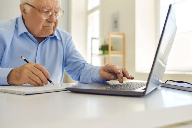 Photo of a senior man researching the difference between a will and living trust