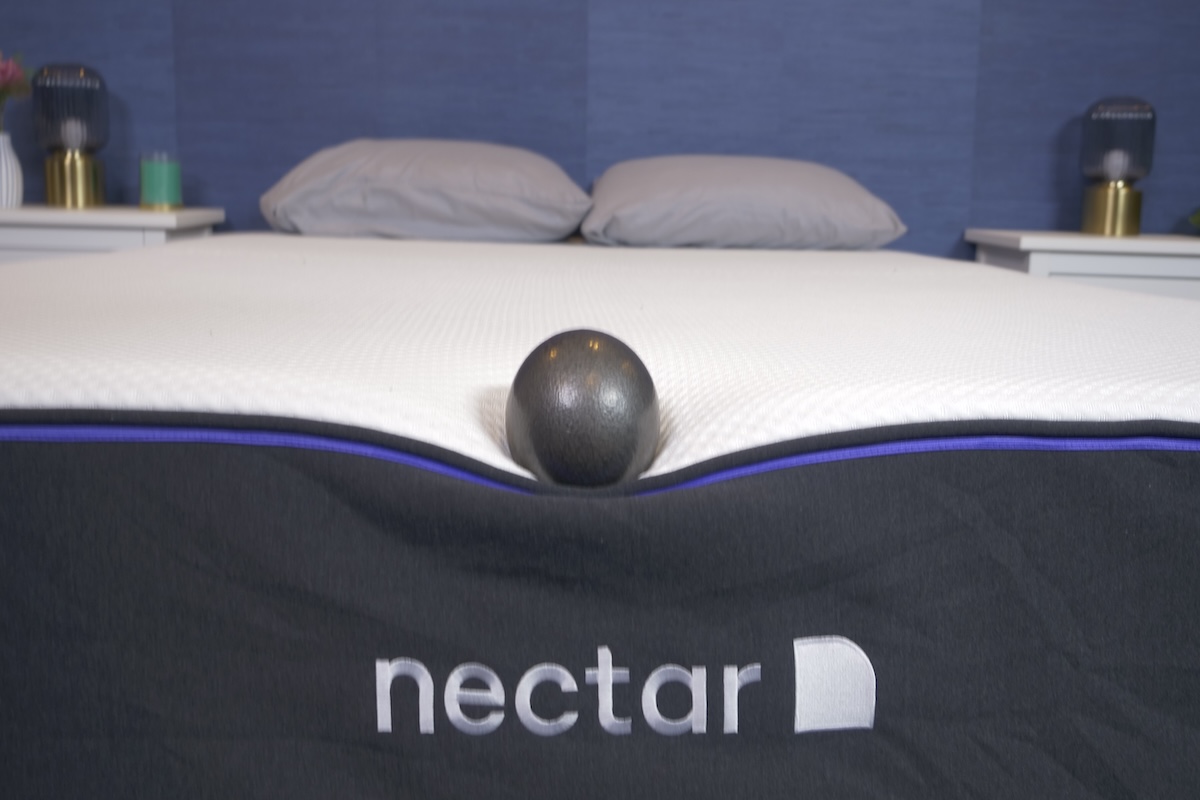Person sitting on the edge of the Nectar Premier mattress