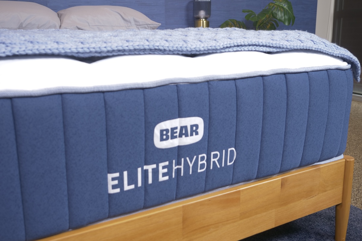 The Bear Elite Hybrid mattress on a wooden bed frame