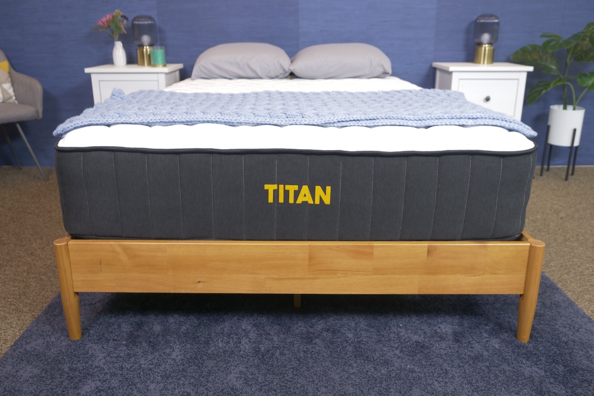 Titan Plus mattress on a light wood bed frame in a bedroom setting