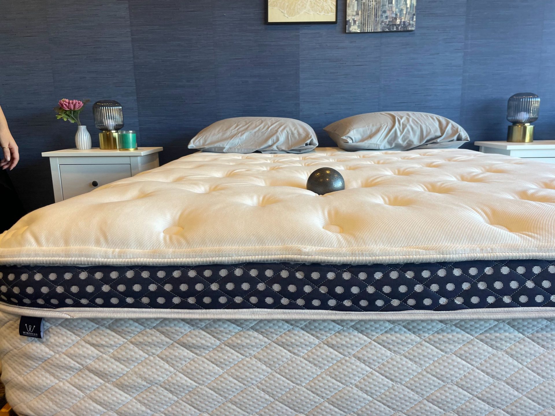 The WinkBed mattress with a weighted ball in the center to test the mattress’s firmness.
