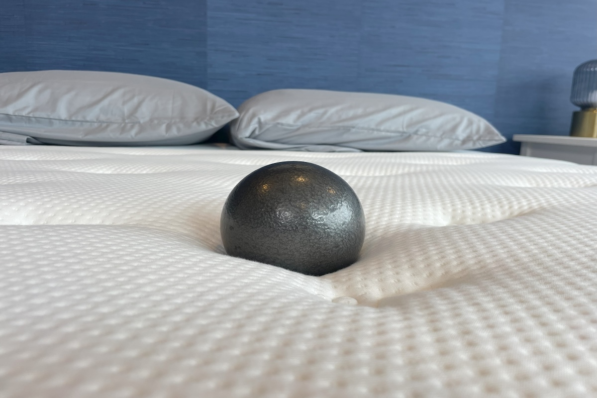 A 10-pound ball sits on the Brooklyn Bedding Signature Hybrid