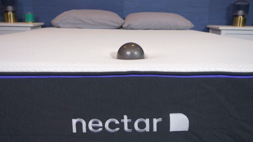  A weighted-ball resting on the lower half of the Nectar Premier Foam mattress.
