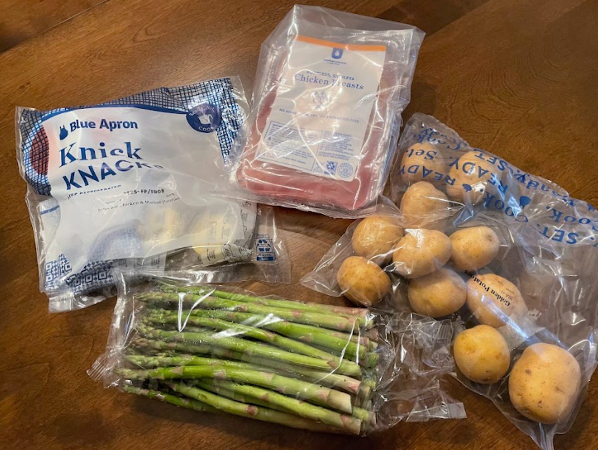 Individually wrapped chicken, potatoes, and asparagus